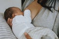 Mother breastfeeding her baby on the bed Royalty Free Stock Photo