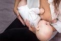 Mother is breastfeeding her baby on the bed Royalty Free Stock Photo