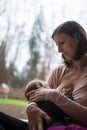 Mother breastfeeding her baby girl in her arms with a loving nurturing look Royalty Free Stock Photo