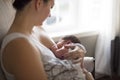 Mother breastfeeding her little baby boy in arms. Royalty Free Stock Photo