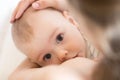 Mother breastfeeding her little boy. Mom nursing and feeding baby. Close-up portrait.