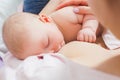 Mother breastfeeding her newborn baby in a bed Royalty Free Stock Photo