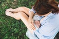 Mother breastfeeding newborn baby child on nature Royalty Free Stock Photo