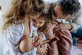 Mother breastfeeding newborn, big sister looking at new baby in mom& x27;s arms. Strong family, bonding and parents Royalty Free Stock Photo