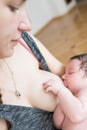 Mother breastfeeds. happy beautiful mother with baby in bed at home. feed the baby before bed