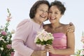 Mother and Bride with bouquet outdoors (portrait) Royalty Free Stock Photo