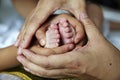 Mom and brother holding baby's feet