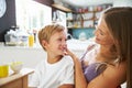 Mother Brushes Son's Hair As He Plays With Digital Tablet Royalty Free Stock Photo