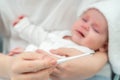 Mother calms crying baby while checking fever. Concept of sick baby Royalty Free Stock Photo