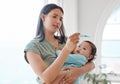 A mother can never be too cautious. a woman taking her babies temperature at home.