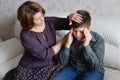 Mother cares for her son who has headache