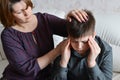 Mother cares for her son who has headache