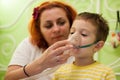 Mother caring kid with aerosols inhalation Royalty Free Stock Photo