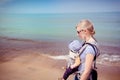 Mother carrying baby son along the beach at the Indiana Dunes National Park Royalty Free Stock Photo