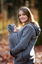 Mother, carrying her baby boy in a sling, outdoors Royalty Free Stock Photo