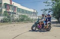 A mother is carrying her chidren on the bike