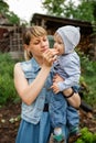 Mother carrying her toddler baby and eat fruit. Mom feeding her son Royalty Free Stock Photo