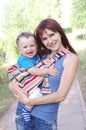 Mother carrys son in baby sling Royalty Free Stock Photo