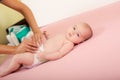 Mother changes the diaper of her baby girl Royalty Free Stock Photo