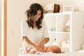 Mother changing baby`s diaper Royalty Free Stock Photo