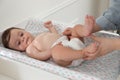 Mother changing baby`s diaper on table at home, closeup Royalty Free Stock Photo