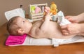 Mother changing diaper of adorable baby Royalty Free Stock Photo