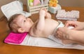 Mother changing diaper of adorable baby Royalty Free Stock Photo