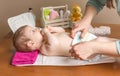 Mother changing diaper of adorable baby Royalty Free Stock Photo