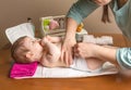 Mother changing diaper of adorable baby Royalty Free Stock Photo