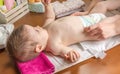 Mother changing diaper of adorable baby Royalty Free Stock Photo