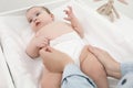 Mother changing baby`s diaper, focus on hands Royalty Free Stock Photo