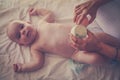 Mother changing diaper her little baby on the bed. Royalty Free Stock Photo