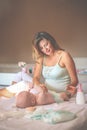 Mother changing diaper her little baby on the bed. Mother using Royalty Free Stock Photo
