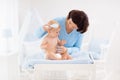 Mother changing diaper to baby boy Royalty Free Stock Photo