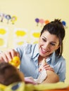 Mother changing diaper to her baby Royalty Free Stock Photo