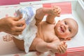 Mother changing diaper to her little baby girl Royalty Free Stock Photo