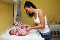 A mother changing her baby nappy . Royalty Free Stock Photo