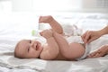 Mother changing her baby`s diaper Royalty Free Stock Photo