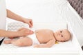 Mother changing her baby`s diaper on table Royalty Free Stock Photo