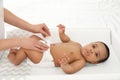 Mother changing her baby`s diaper on table Royalty Free Stock Photo