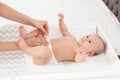 Mother changing her baby`s diaper on table Royalty Free Stock Photo