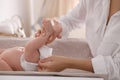 Mother changing her baby`s diaper on table, closeup Royalty Free Stock Photo