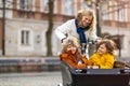 Mother checking on her children who is riding in a cargo bike