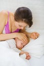 Mother checking temperature of forehead of baby