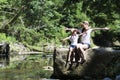 Mother and child adventure in mountain stream