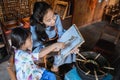 Mother and child asian making batik pattern