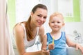 Mother with child boy brushing teeth Royalty Free Stock Photo