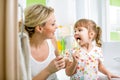 Mother and child brushing teeth in bathroom Royalty Free Stock Photo