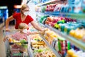 Mother and child buying fruit in supermarket