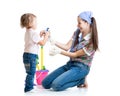 Mother with child cleaning room and having fun